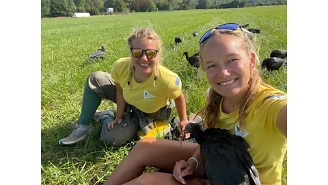 Waldrappteam The "foster mothers" with their hand-reared bald ibises (Credit: Waldrappteam)