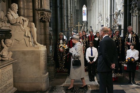 Queen Elizabeth II lays a wreath on a statue of William Wilberforce in Westminster Abbey 
