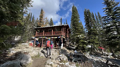 Phoebe Smith Plain of 6 Glaciers Teahouse is nestled in the woods and festooned with Nepalese prayer flags (Credit: Phoebe Smith)