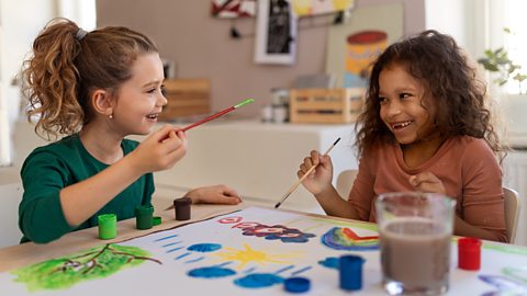 Girls smiling and painting