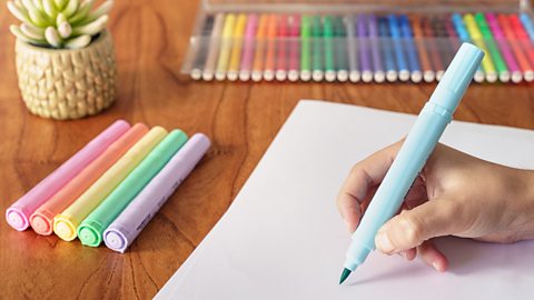 Person drawing with blue marker pen