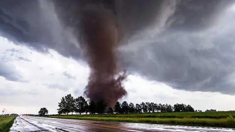 Getty Images A tornado approaches a road in Nebraska (Credit: Getty Images)