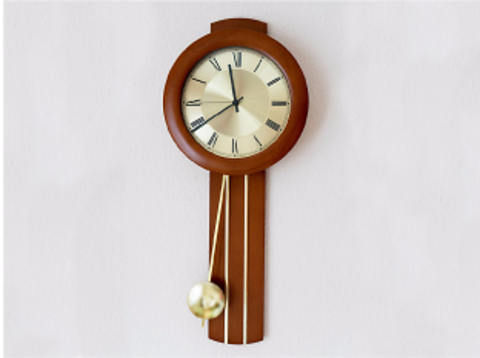 Clock with pendulum swinging to the left