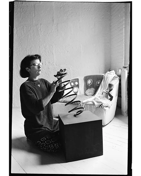 Courtesy of Cherry archive Cherry – pictured with her artworks in the 1980s – explored various mediums including ceramics, collage and tapestry (Credit: Courtesy of Cherry archive)