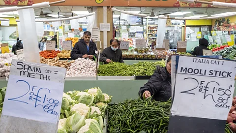 Getty Images Signs showing discount prices for buying two items at a vegetable market stall (Credit: Getty Images)