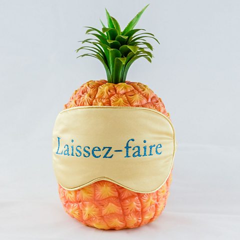 pineapple made of material with a face mask saying Laissez Faire