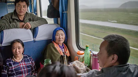 Imaginechina Limited/Alamy Riding alongside Tibetans is one of the most rewarding parts of the Qinghai-Tibet railway (Credit: Imaginechina Limited/Alamy)