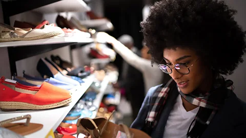 Getty Images Shopper browsing in vintage shoe store