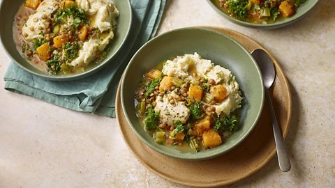 Chicken kale stew served in a bowl with rice