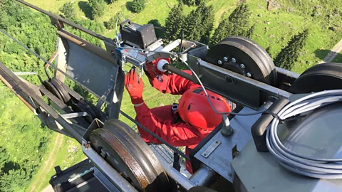 University of Stuttgart A researcher inspects the steel rope of a cable car for safety (Credit: Institute of Mechanical Handling and Logistics, University of Stuttgart)