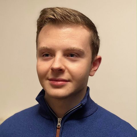 A head and shoulders shot of Coel Aspey, who is smiling and looking slightly to the side of the camera.