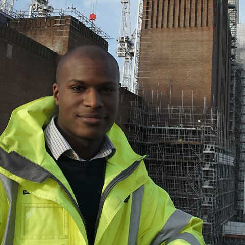 A young man at work on a construction site.