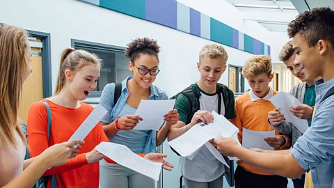 We All Passed! Students looking at their exam results.