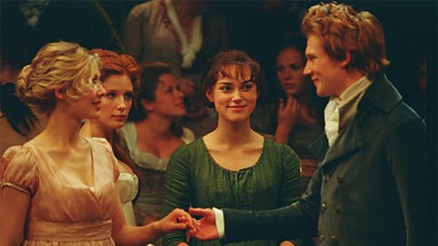 Jane meets Bingley for the first time. They are holding hands and Elizabeth is smiling at them.