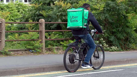 Alamy Uber Eats worker delivering in the UK on bike