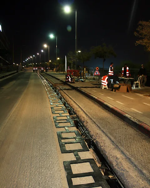 Electreon The induction coils are installed just below the road surface and connected to the electricity grid, as in this stretch of road in Tel Aviv, Israel (Credit: Electreon)