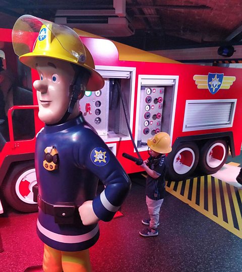 young boy pretending to be a firefighter