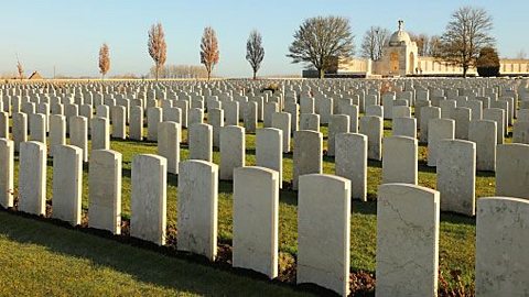 Rows of identical white gravestones as far as the eye can see