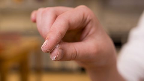 A close up of a persons thumb and forefinger