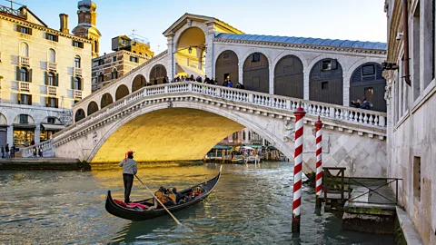 westend61/Getty Images The Rialto Bridge connects the sestieri of San Polo and San Marco, and is one of Venice's most impressive and visited landmarks (Credit: westend61/Getty Images)