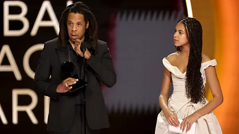 Getty Images Jay-Z, shown on stage with Blue Ivy Carter, used his speech to ask why Beyoncé hadn't received the Grammys' album of the year award (Credit: Getty Images)