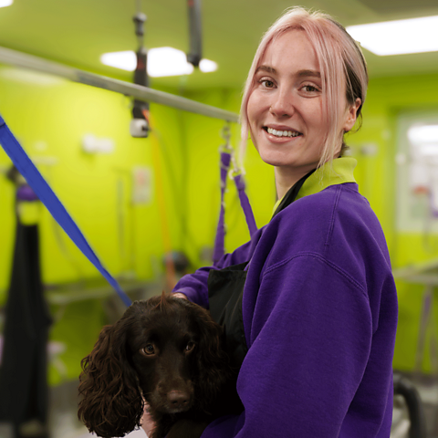Apprentice dog groomer, Rebecca, with a furry client.