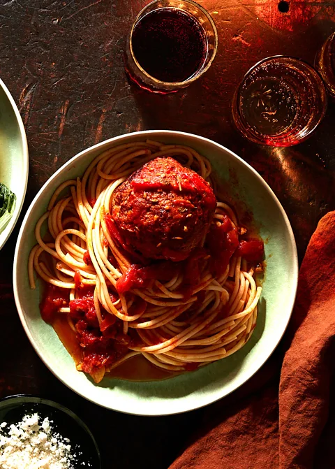 Johnny Miller This Shanghainese-style meatball sits on top of a plate of tomato-sauced spaghetti (Credit: Johnny Miller)
