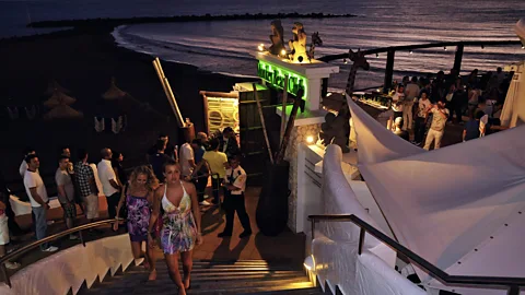 Image Professionals GmbH/Alamy Stock Photo Party through the sunset and deep into the night at Monkey Beach Club on Playa de Troya, a chic yet laid back nightspot (Credit: Image Professionals GmbH/Alamy Stock Photo)