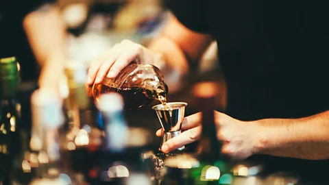 Rafael Elias/Getty Images Bartender pouring cocktails (Credit: Rafael Elias/Getty Images)