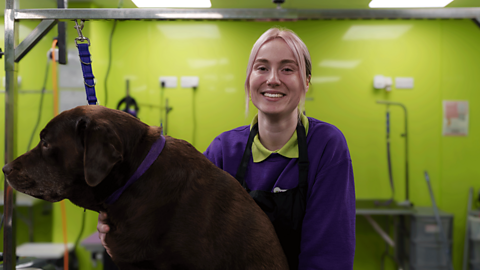 Apprentice dog groomer, Rebecca, with one of her furry clients. 