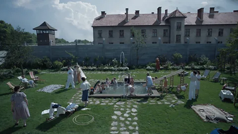 A24 The film is set within the affluent home of Auschwitz commander Rudolf Höss – whose garden backs on to the camp (Credit: A24)