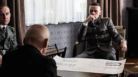 A24 Rudolf Höss is shown in a meeting – but the appalling consequences of his command are audible only (Credit: A24)
