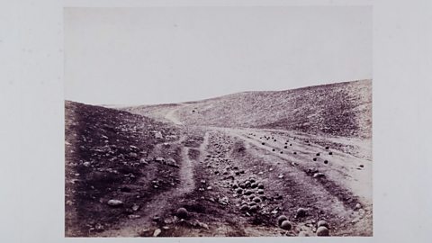 Cannonballs lying in the valley where a battle has just taken place.