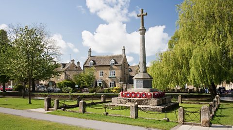 A war memorial on a village green in England.