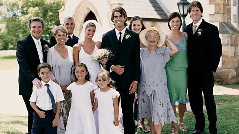 A Family With the Bride and Groom stood outside a Church.