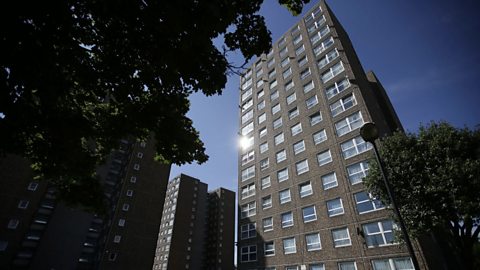 A residential tower block in London with trees.