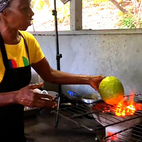 Cynthia's Restaurant Cynthia roasts whole breadfruit over an open flame for about 20 minutes before slicing it (Credit: Cynthia's Restaurant)