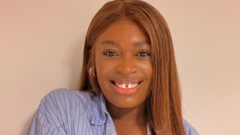 A photo of Jennifer Opal against a neutral background. She is smiling directly at the camera.