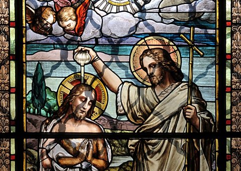 Stained glass window of Jesus' baptism