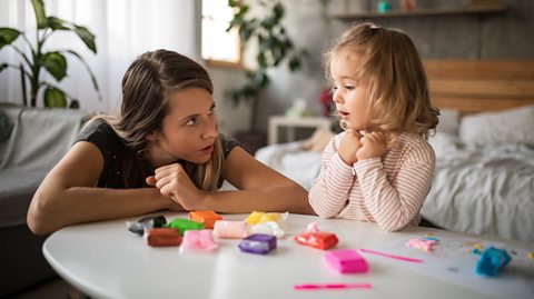 mum speaking to her daughter about telling tales