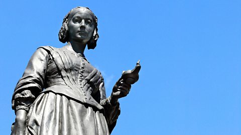 An image of a statue of Florence Nightingale against a bright blue sky. 