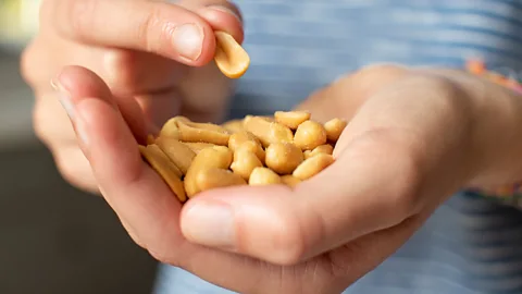 Getty Images hand with peanuts (Credit: Getty Images)