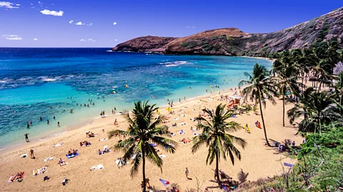 John Seaton Callahan/Getty Images People on beach at Hanauma Bay Nature Preserve in Hawaii