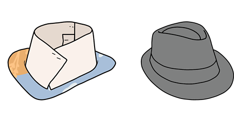 A cardboard model of hat next to a black fedora