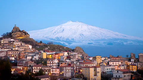 Blueplace/Getty Images Mount Etna with an Italian town in the foreground