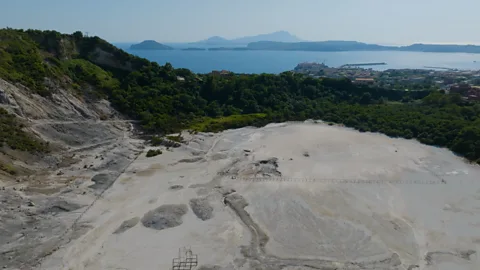 Pomona Pictures The Solfatara is like an alien landscape with pale, bubbling mud and steam (Credit: Pomona Pictures)