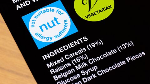 A black label with white text, listing out ingredients of a cereal bar 