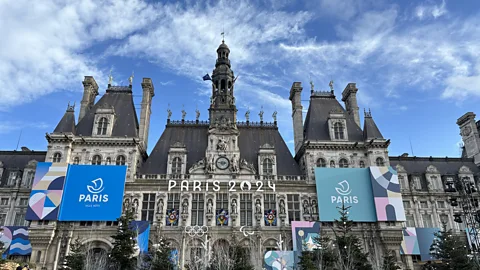 Aysenur Dincer/Getty Images Hotel de Ville building with signs for Paris Olympic Games 2024