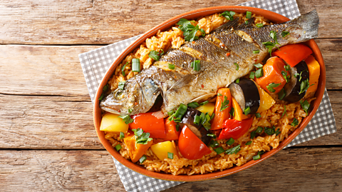 One-pot ceebu jën with vegetables in a dish on a table