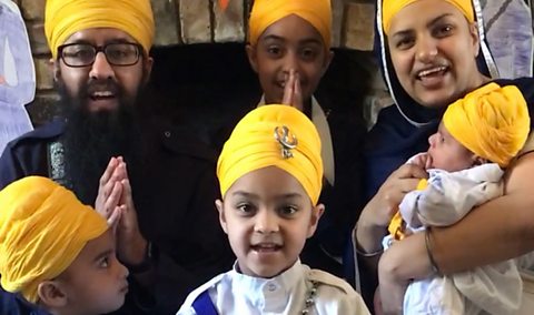 Gurpreet's family pose in front of the fireplace wearing traditional Sikh turbans